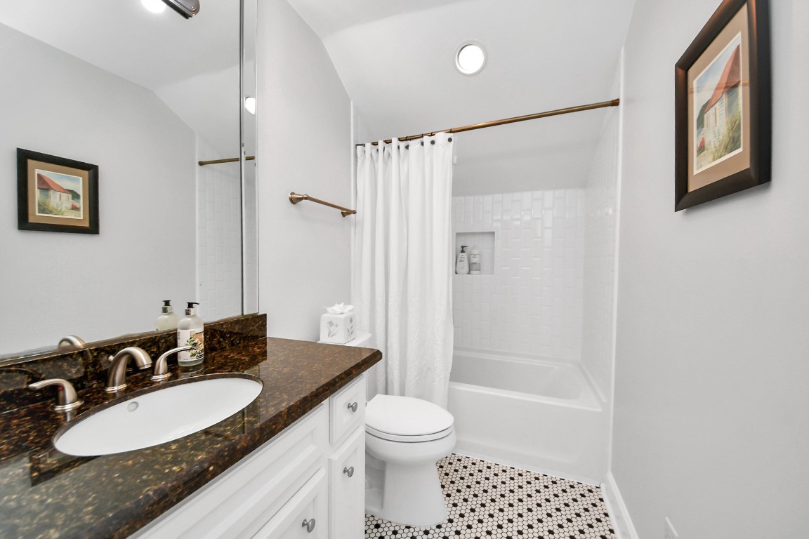 6302 Hermann Lake Drive Houston, TX 77021 - Photo 40 of 50 a bathroom with a granite countertop sink toilet a mirror and shower