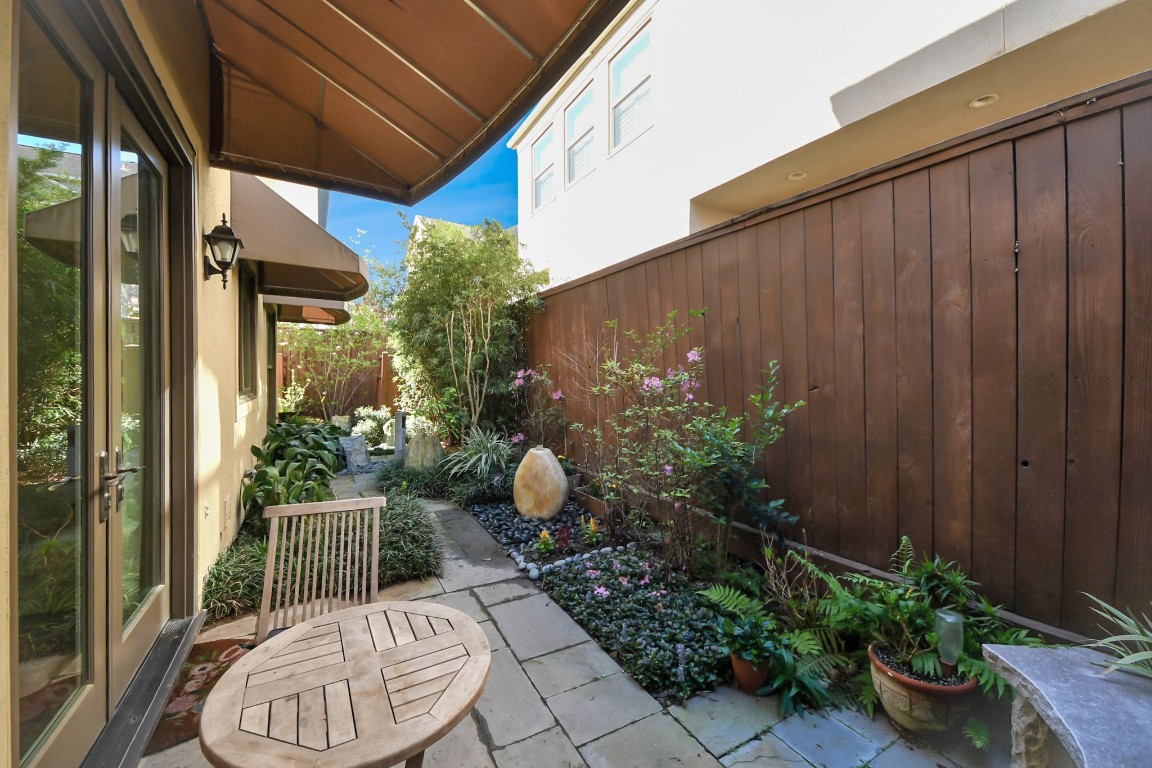 6302 Hermann Lake Drive Houston, TX 77021 - Photo 44 of 50 a backyard of a house with a fountain plants and wooden fence