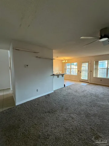 a view of empty room with floor to ceiling window