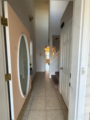 a view of a hallway with windows and stairs