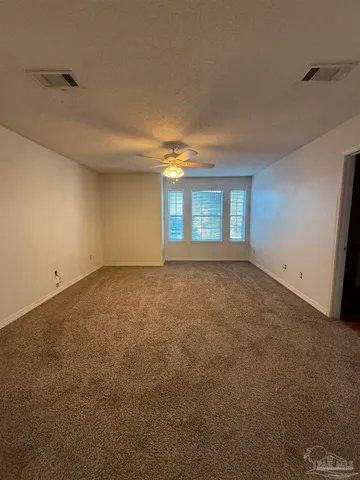 an empty room with a empty space and windows