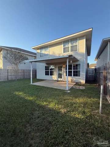 a view of a house with backyard porch and sitting area