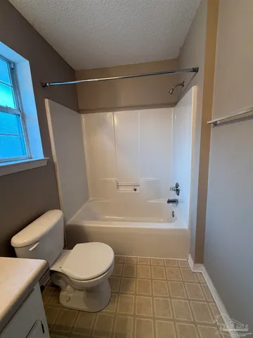 a bathroom with a toilet a sink and bathtub