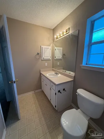a bathroom with a sink toilet and mirror