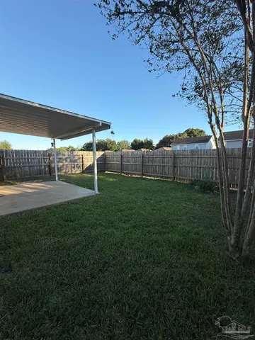 a view of a big yard with a house