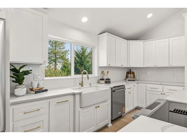 a kitchen with a sink window and cabinets