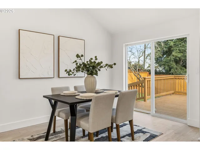 a view of a dining room with furniture and a potted plant