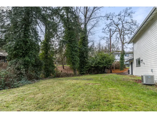 a backyard of a house with lots of green space