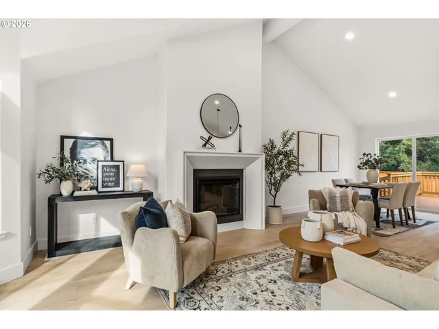 a living room with furniture a fireplace and a table