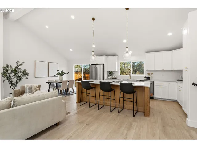 a living room with lots of furniture and a wooden floor