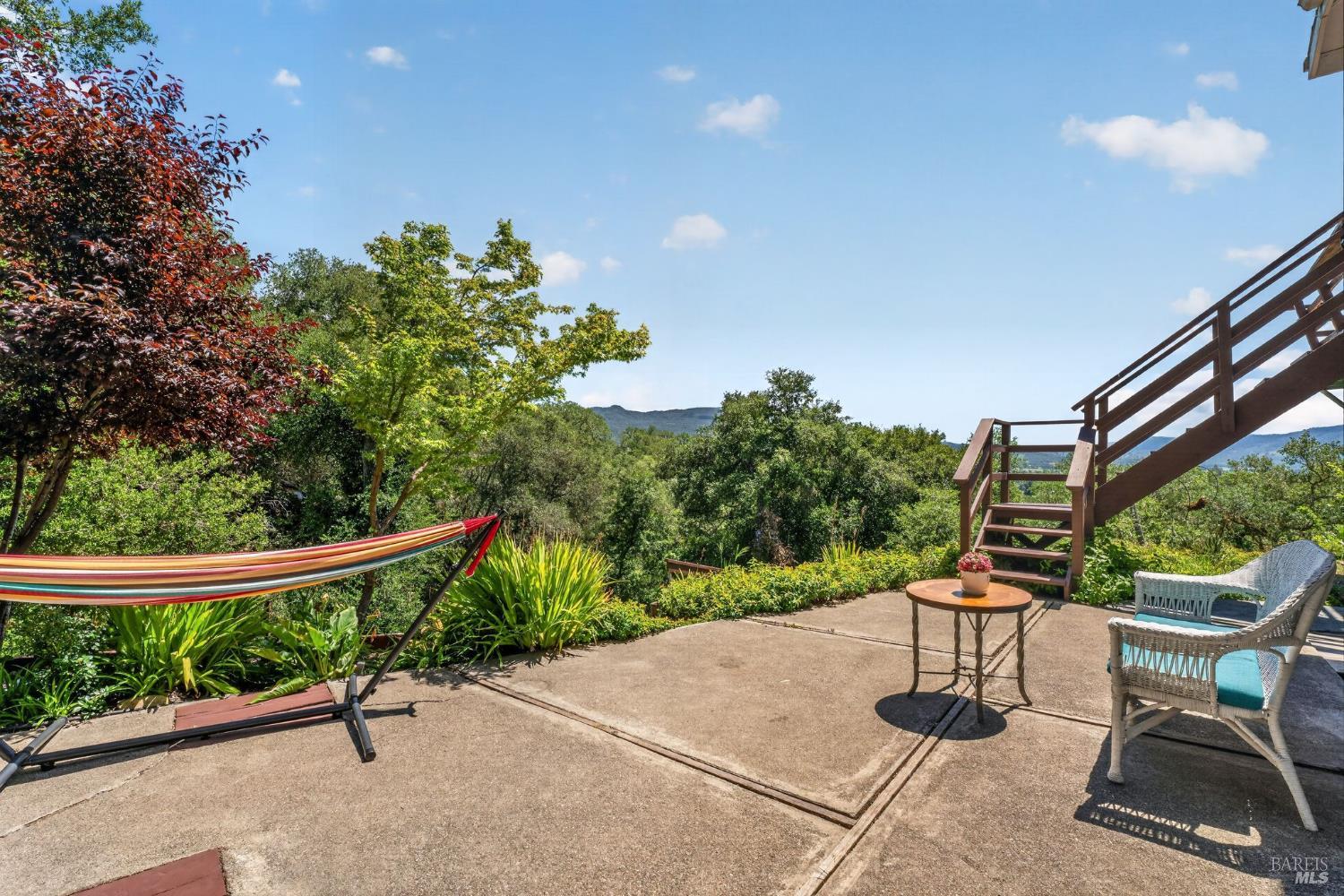891 Isola Way Ukiah, CA 95482 - Photo 11 of 46 a roof deck with table and chairs and potted plants