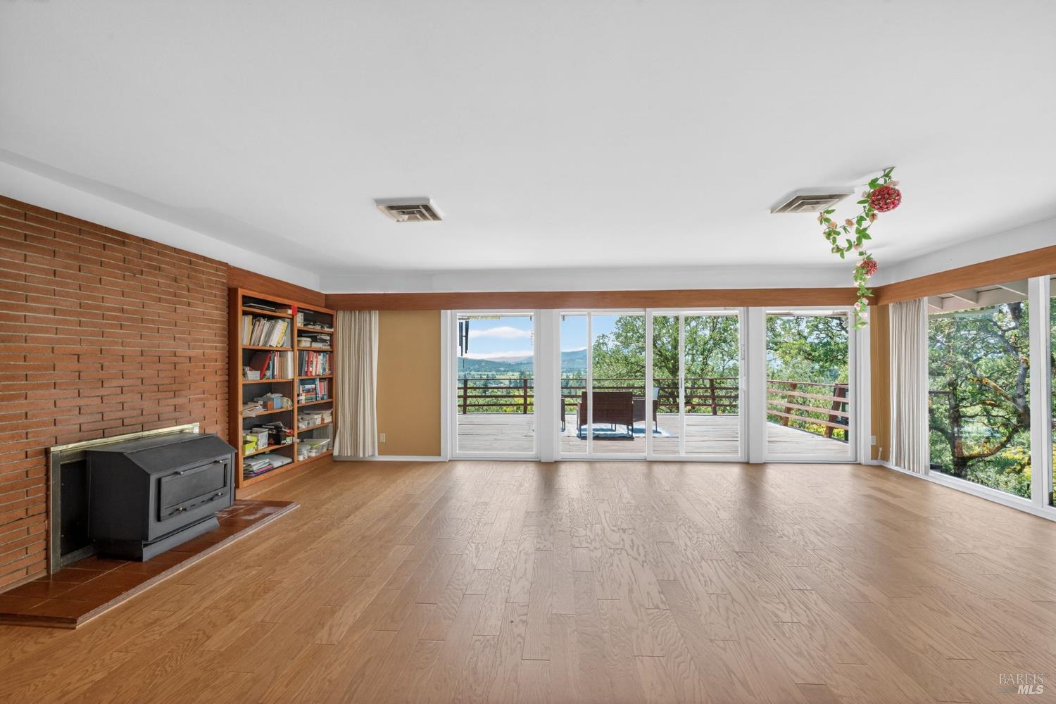 891 Isola Way Ukiah, CA 95482 - Photo 27 of 46 a view of an empty room with wooden floor and a window