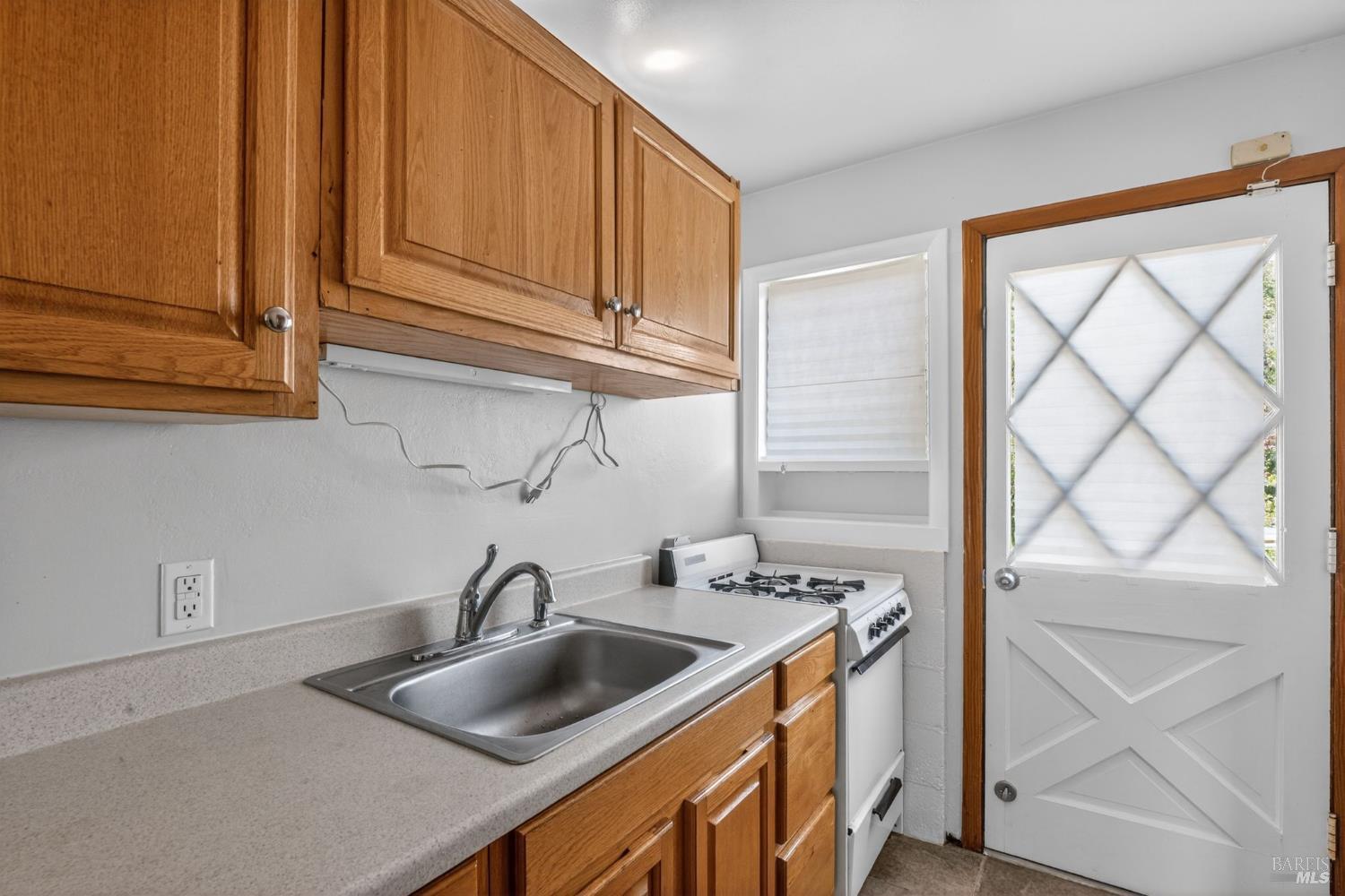 891 Isola Way Ukiah, CA 95482 - Photo 40 of 46 a kitchen with stainless steel appliances granite countertop a sink and a white cabinets