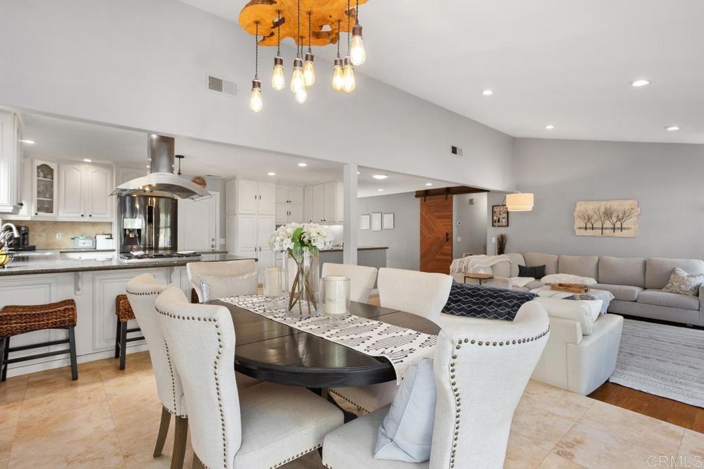 2804 Jacaranda Avenue Carlsbad, CA 92009 - Photo 11 of 36 a dining room with furniture a chandelier and kitchen view