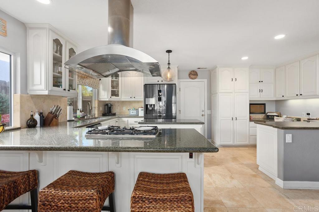 2804 Jacaranda Avenue Carlsbad, CA 92009 - Photo 12 of 36 a kitchen with stainless steel appliances granite countertop a sink stove and cabinets