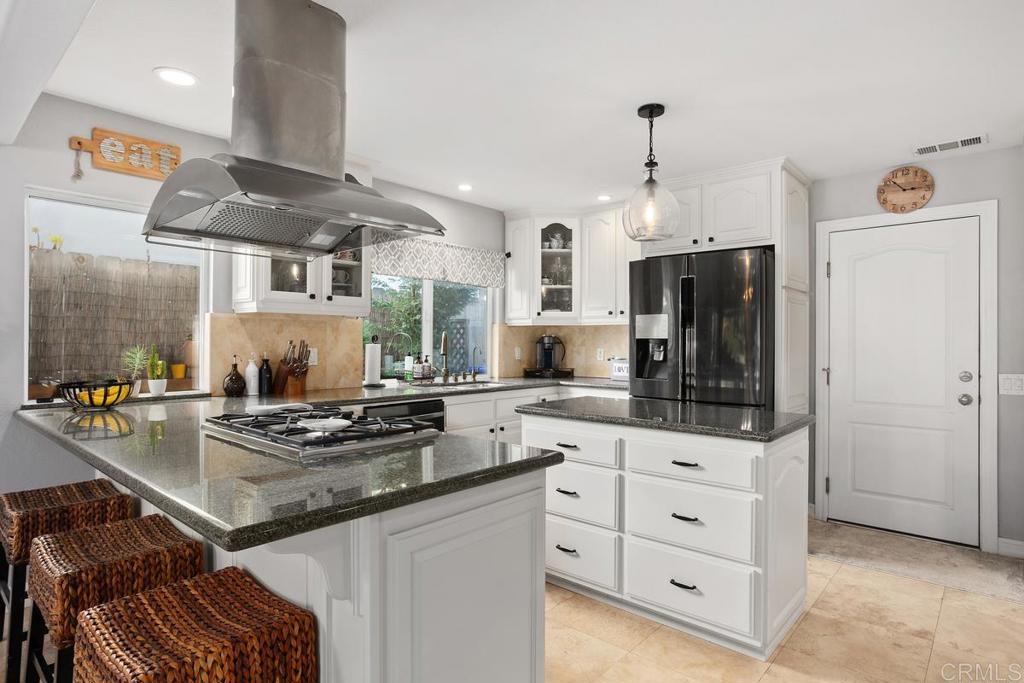 2804 Jacaranda Avenue Carlsbad, CA 92009 - Photo 13 of 36 a kitchen with granite countertop a sink cabinets and stainless steel appliances