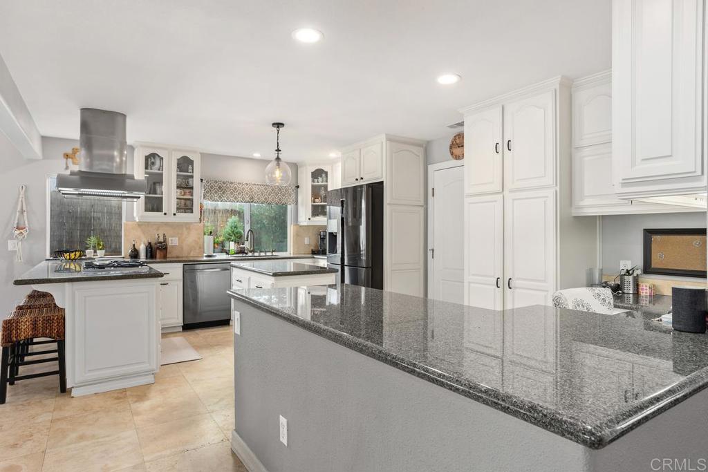 2804 Jacaranda Avenue Carlsbad, CA 92009 - Photo 14 of 36 a large kitchen with kitchen island a large counter top stainless steel appliances and cabinets