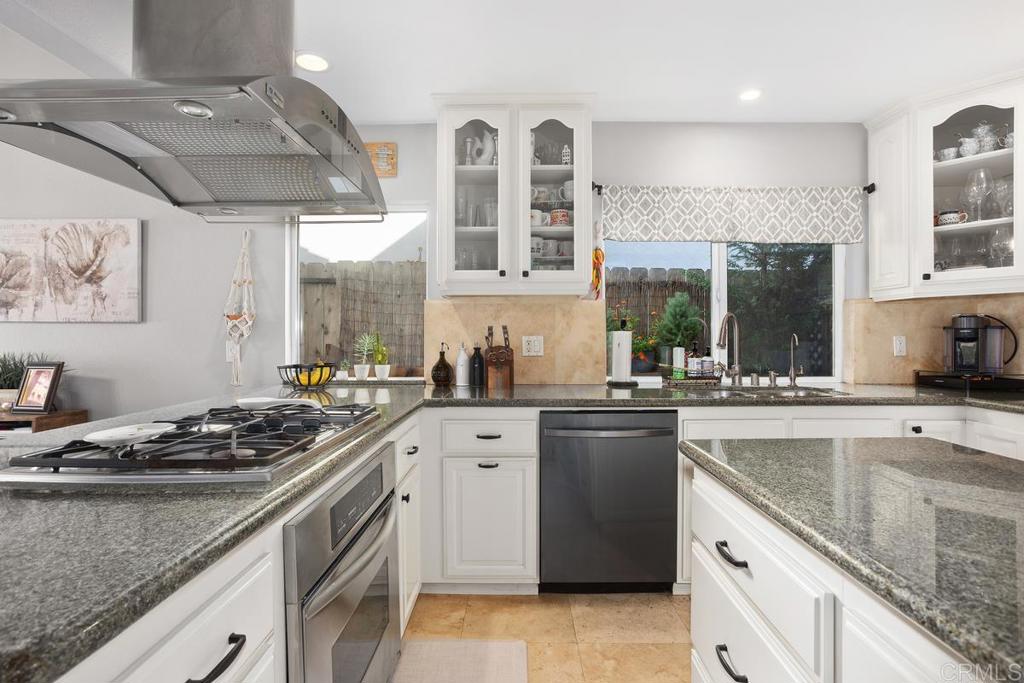 2804 Jacaranda Avenue Carlsbad, CA 92009 - Photo 15 of 36 a kitchen with stainless steel appliances granite countertop a sink stove and cabinets