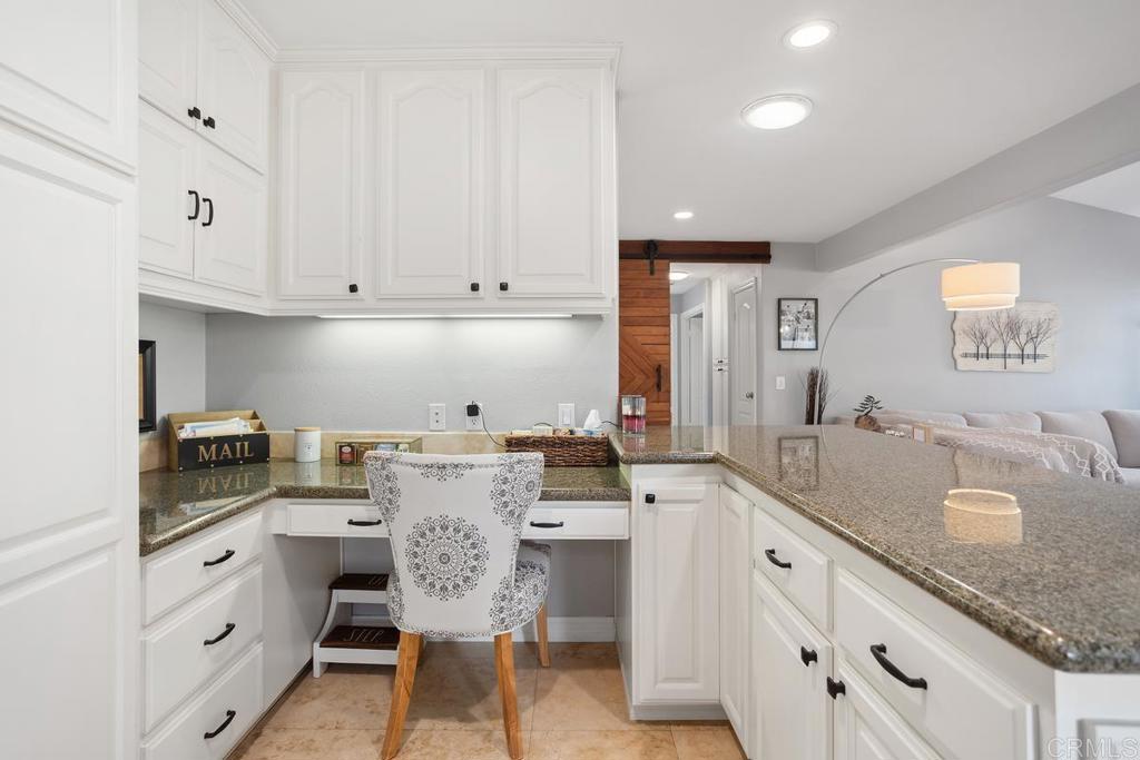 2804 Jacaranda Avenue Carlsbad, CA 92009 - Photo 17 of 36 a kitchen with granite countertop white cabinets and white appliances