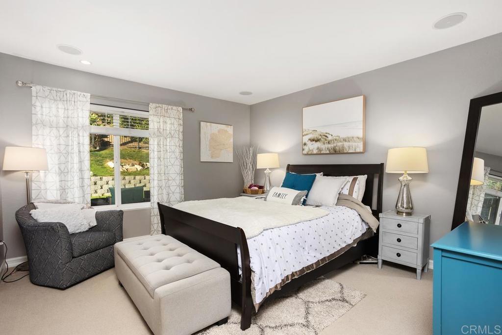 2804 Jacaranda Avenue Carlsbad, CA 92009 - Photo 18 of 36 a bedroom with a bed couch and a large window