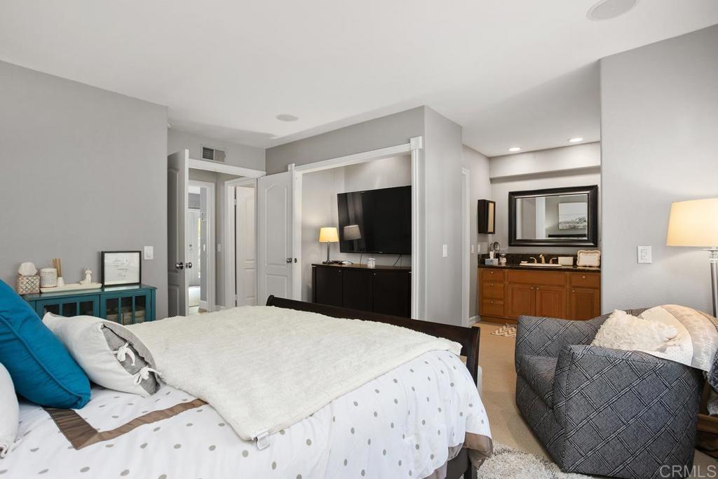 2804 Jacaranda Avenue Carlsbad, CA 92009 - Photo 20 of 36 a bedroom with a bed and wooden floor