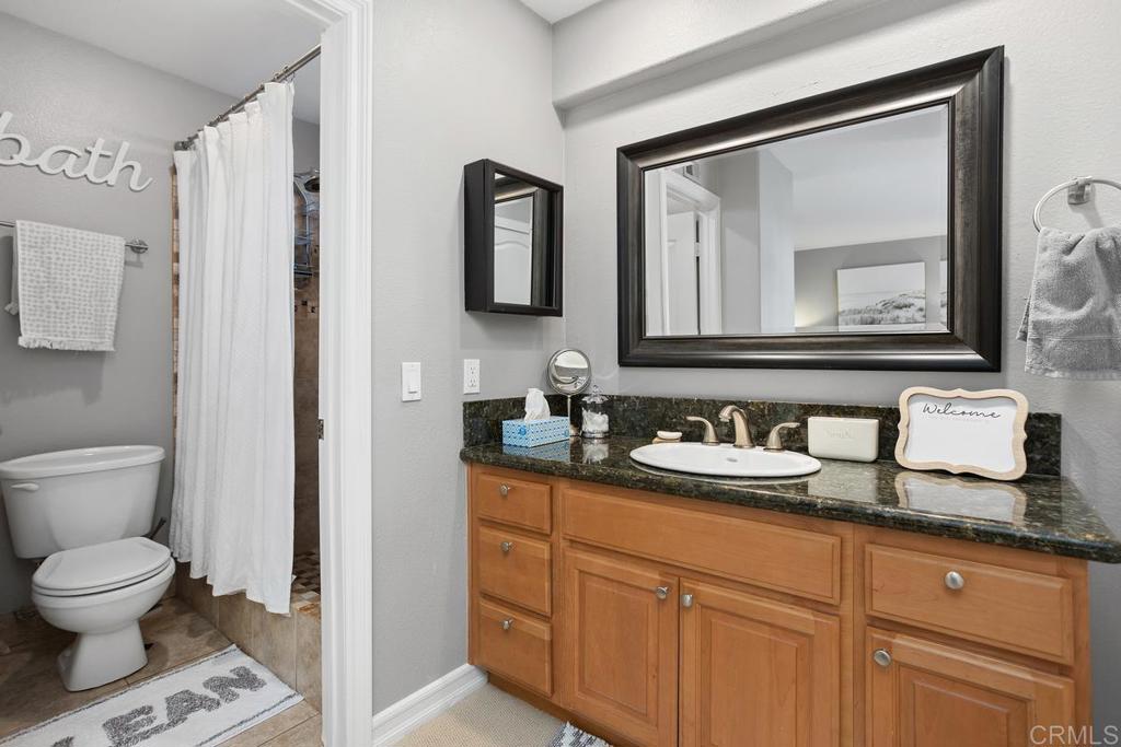 2804 Jacaranda Avenue Carlsbad, CA 92009 - Photo 21 of 36 a bathroom with a toilet sink and mirror