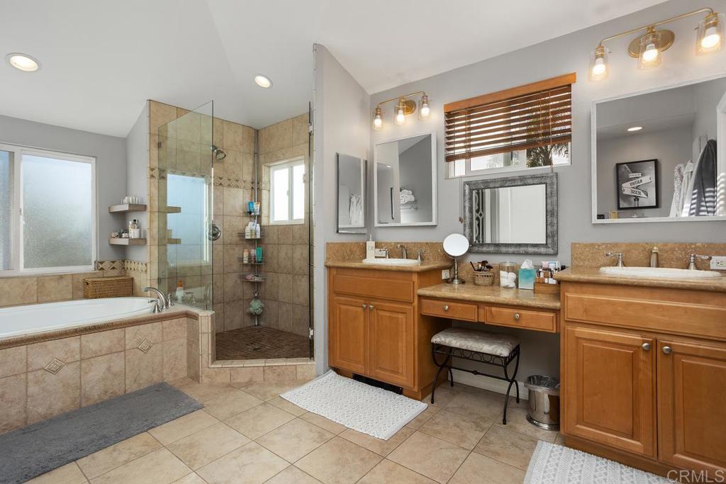 2804 Jacaranda Avenue Carlsbad, CA 92009 - Photo 28 of 36 a bathroom with a sink a toilet a mirror and shower