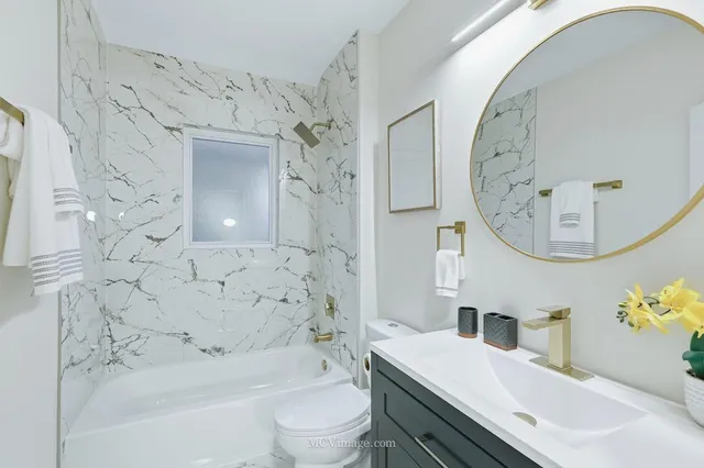 a bathroom with a sink a toilet and a mirror