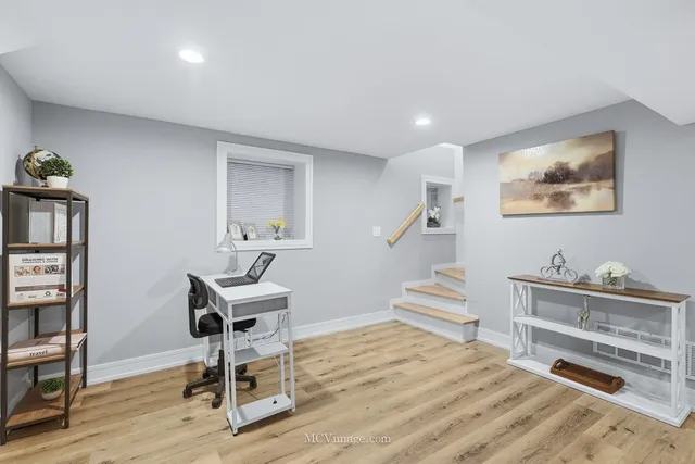 a bedroom with furniture and a wooden floor