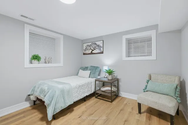 a bedroom with a bed and a chair