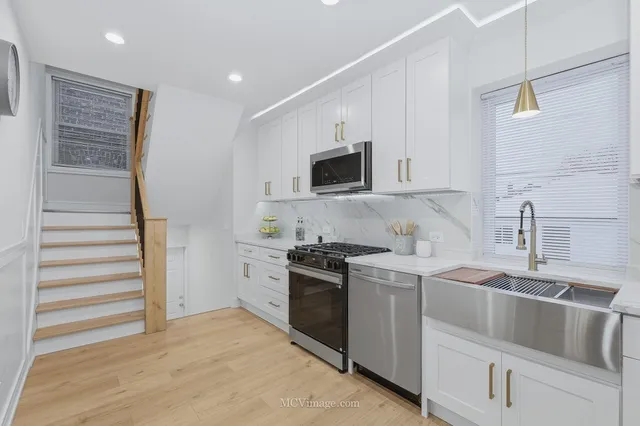 a kitchen with a sink stove and refrigerator