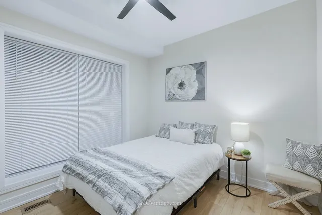 a bedroom with a bed and painting on the wall