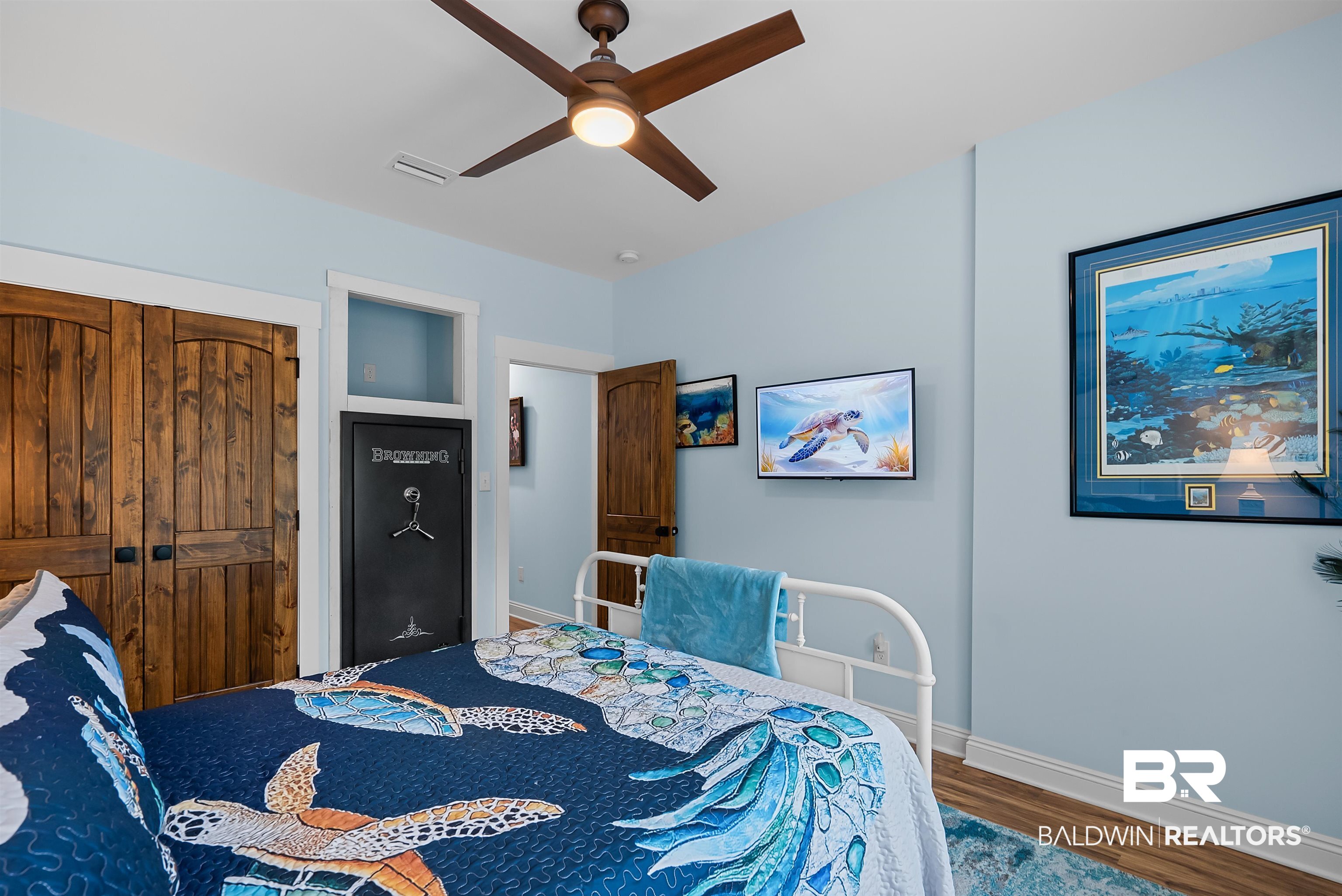 7266 Franklin Road Foley, AL 36535 - Photo 36 of 64 Bedroom featuring wood-finish flooring, light blue wall paint, a ceiling fan with integrated lighting, and white trim