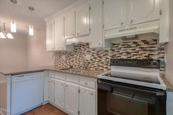 a kitchen with stainless steel appliances granite countertop a stove and a sink