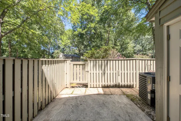a view of a porch with wooden floor and fence and a floor to ceiling window