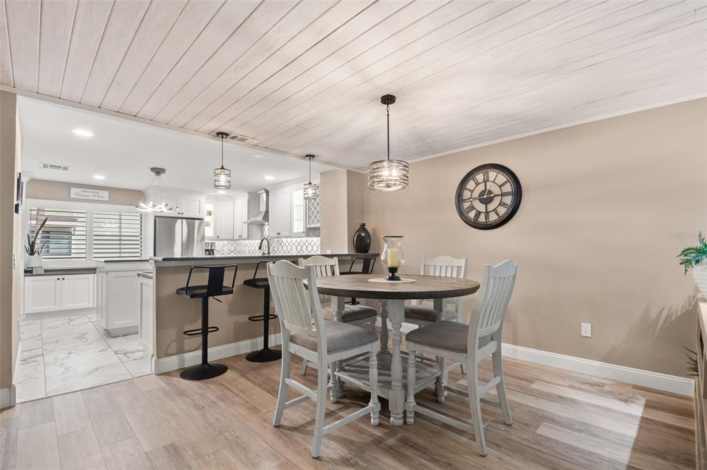 529 Sandy Hook Road Treasure Island, FL 33706 - Photo 19 of 55 a view of a dining room with furniture and wooden floor