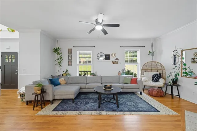 a living room with furniture and wooden floor