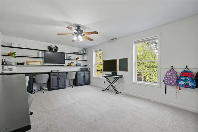 a view of a livingroom with workspace and a window