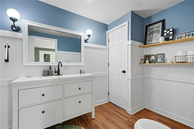 a spacious bathroom with a double vanity sink a mirror and a shower
