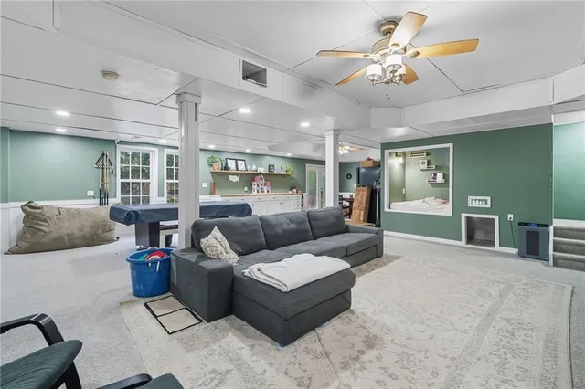 a living room with furniture and kitchen view