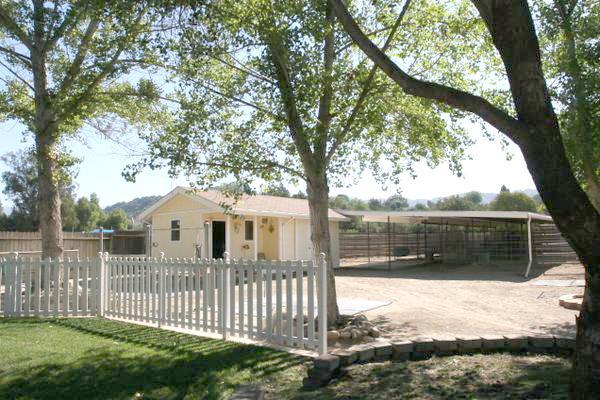 210 Burnham Road Oak View, CA 93022 - Photo 17 of 17 a view of a house with a wooden deck next to a yard