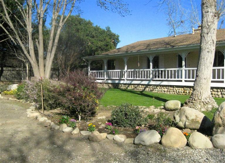 210 Burnham Road Oak View, CA 93022 - Photo 3 of 17 a front view of a house with a yard and potted plants