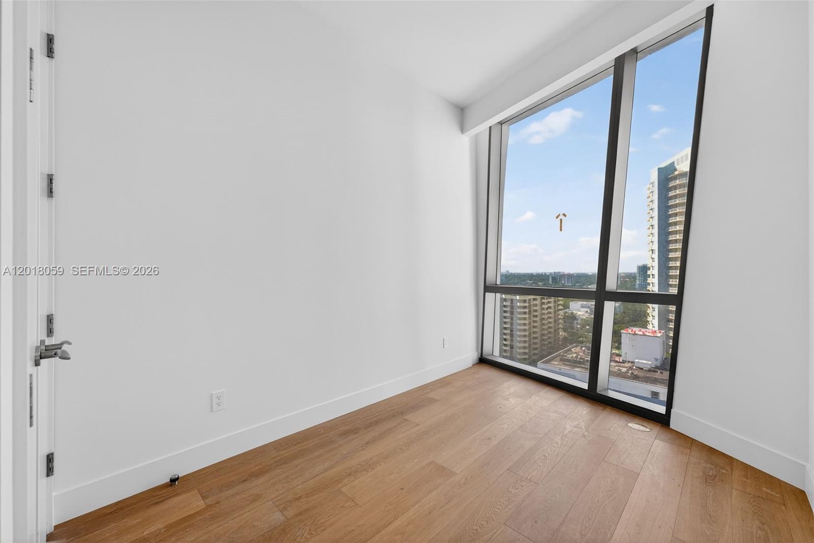 175 Southeast 25th Road, Unit 1004 Miami, FL 33129 - Photo 21 of 40 wooden floor in an empty room with a window
