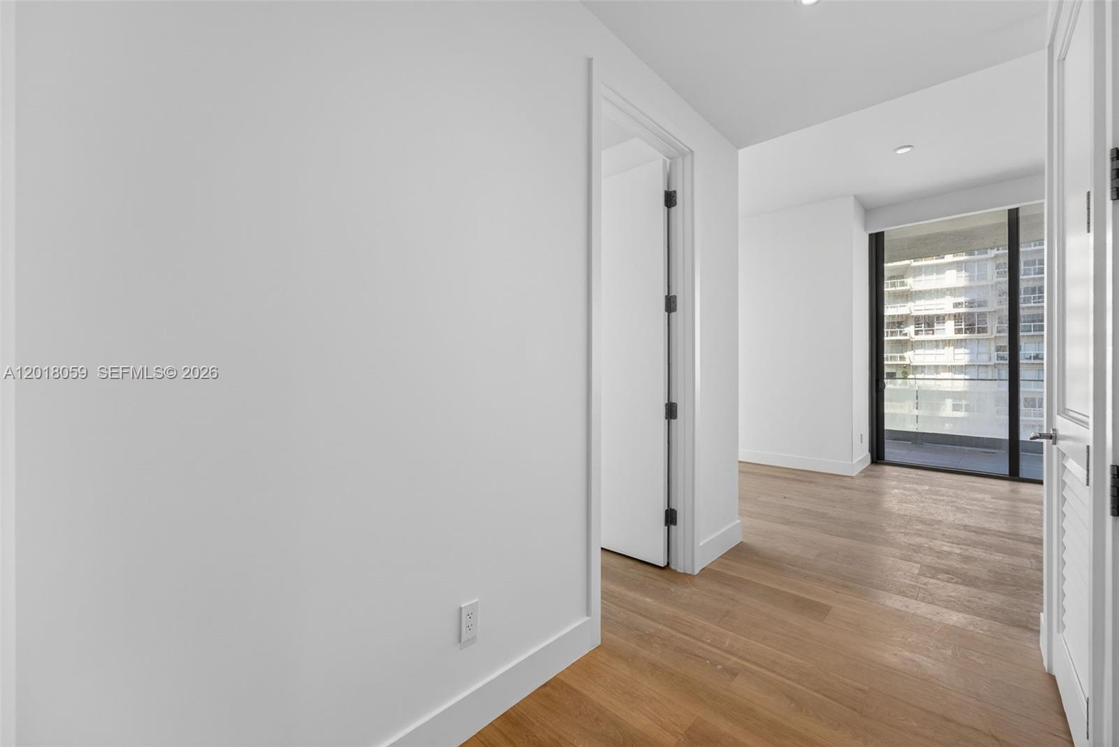 175 Southeast 25th Road, Unit 1004 Miami, FL 33129 - Photo 24 of 40 a view of an empty room with wooden floor and a window
