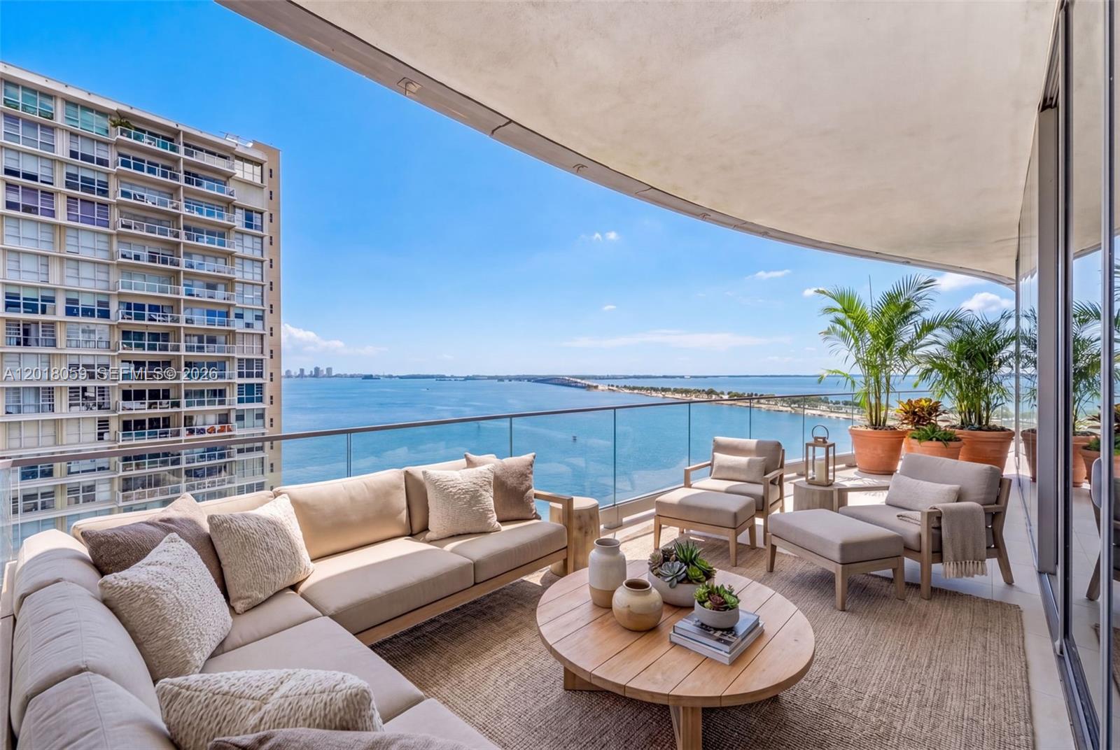 175 Southeast 25th Road, Unit 1004 Miami, FL 33129 - Photo 4 of 40 a balcony with furniture and a potted plant