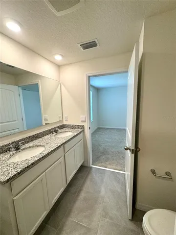 a bathroom with a double vanity sink and mirror