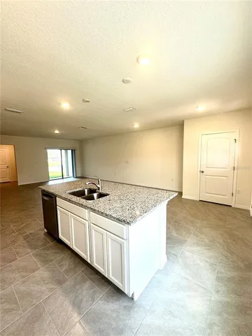 a kitchen with stainless steel appliances granite countertop a sink and a stove