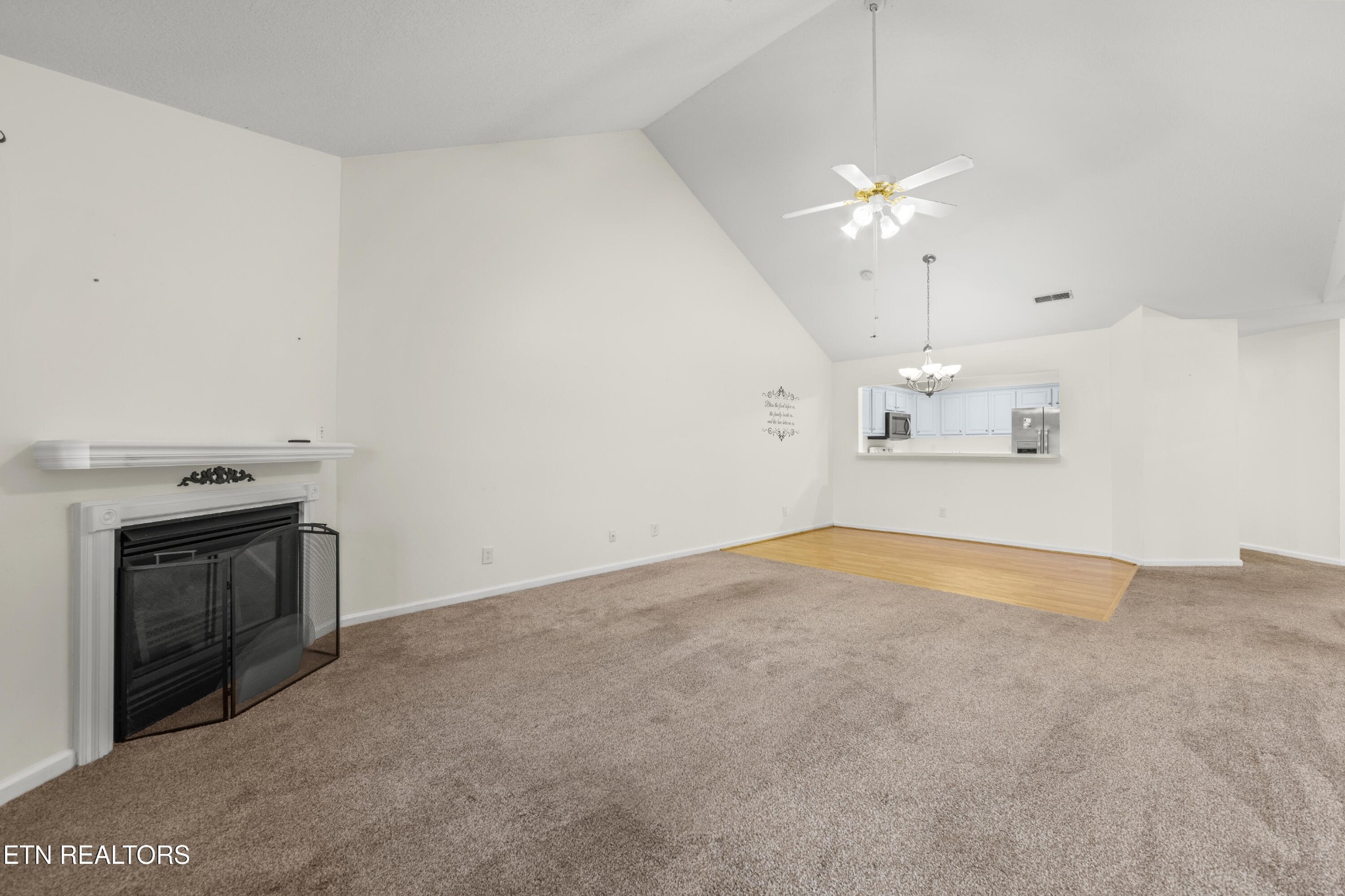 1218 Ernest McMahan Road Sevierville, TN 37862 - Photo 12 of 40 an empty room with chandelier fan and fireplace