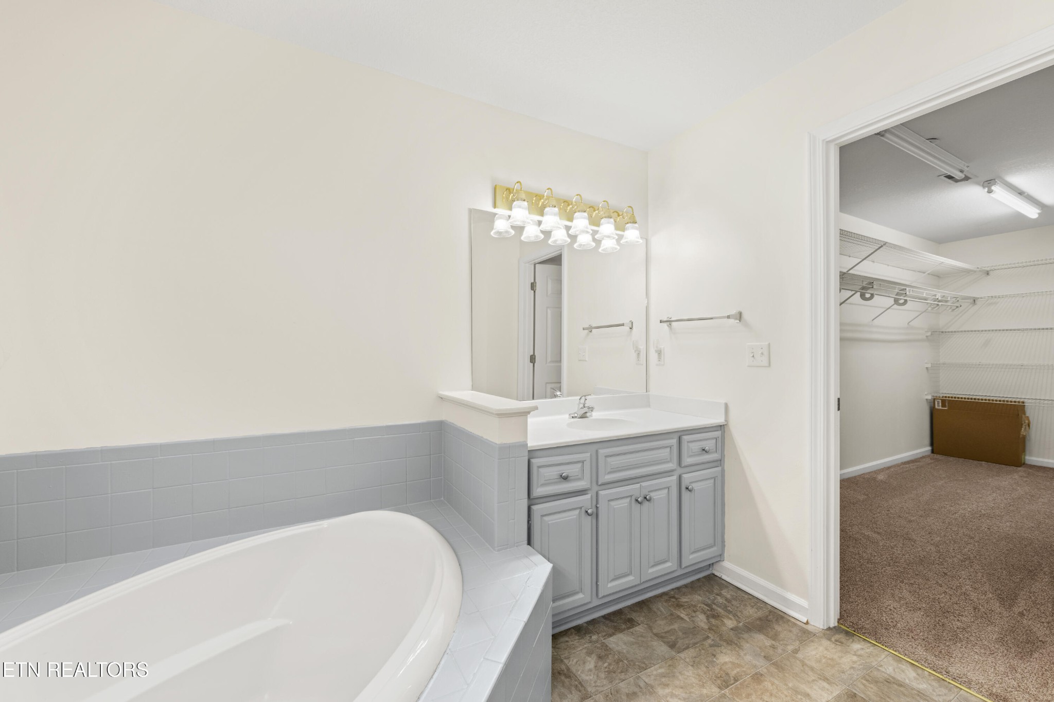 1218 Ernest McMahan Road Sevierville, TN 37862 - Photo 27 of 40 a spacious bathroom with a bathtub sink and mirror