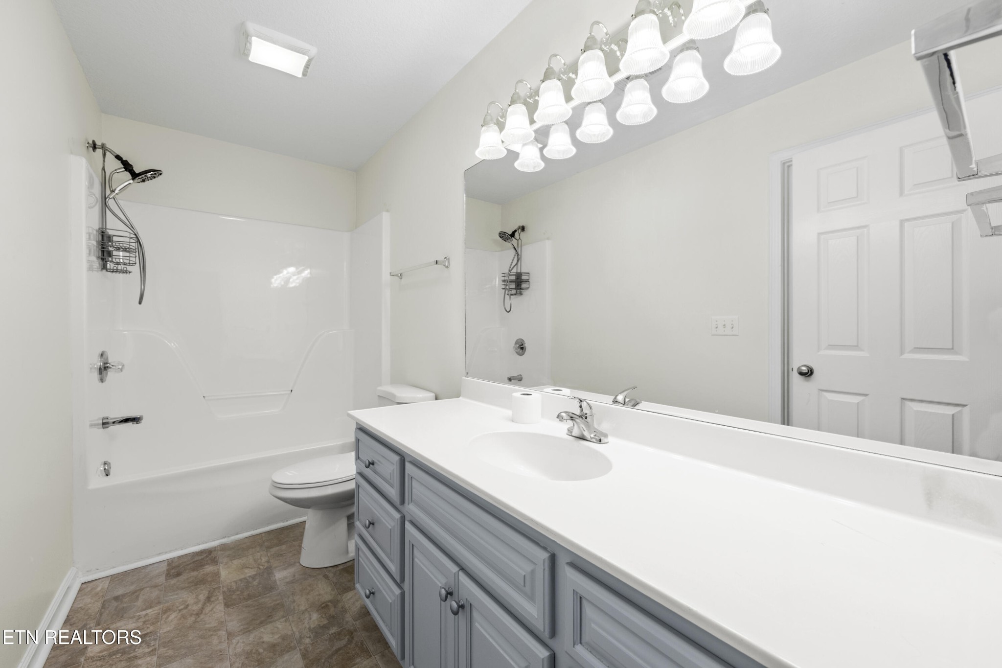 1218 Ernest McMahan Road Sevierville, TN 37862 - Photo 7 of 40 a bathroom with a sink a toilet a large mirror and shower